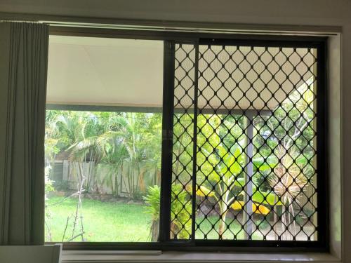 a window with a view of a yard at Holiday Style A downstairs room in Springwood Qld in Springwood