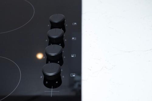 two images of black stools in a room at Cozy single level flat with parking in Enfield