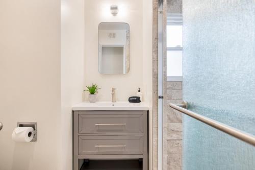 a bathroom with a sink and a mirror at Surfrider Buyout by AvantStay 2 Home Buyout By the Beach in Newport Beach