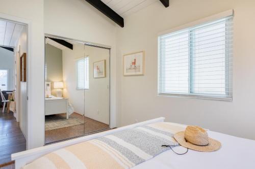 a bedroom with a bed with a hat on it at Surfrider Buyout by AvantStay 2 Home Buyout By the Beach in Newport Beach