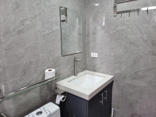 a bathroom with a sink and a toilet and a mirror at C Mary's Staycation in Tanza Cavite Condo Type with balcony good for 2 person in Tanza