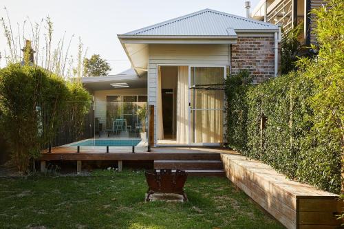 a house with a wooden deck in the yard at The Willows in Wickham