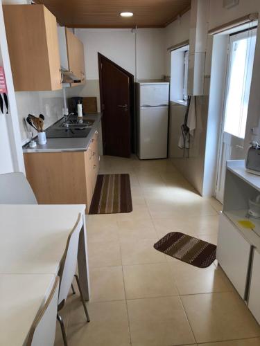 a small kitchen with a sink and a refrigerator at Apartamento 1 Penedo in Sintra