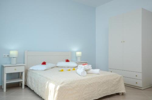 a bedroom with a bed with towels on it at Hotel Francesca in Agios Prokopios