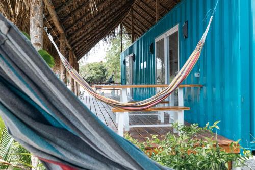 a hammock in front of a blue house at Panama Kite Center in Punta Chame