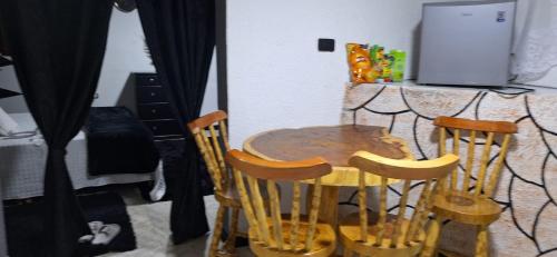 una mesa de madera y 4 sillas en la cocina en la muñeca apartamento, en Pereira