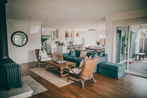 a living room with a couch and a table at Verandah Retreat - A Beach House by the sea in Cowes