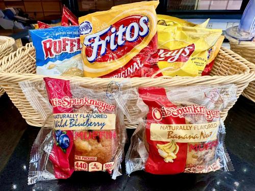 a basket filled with packets of chips and other snacks at Royal Orchid Hotel Guam in Tumon