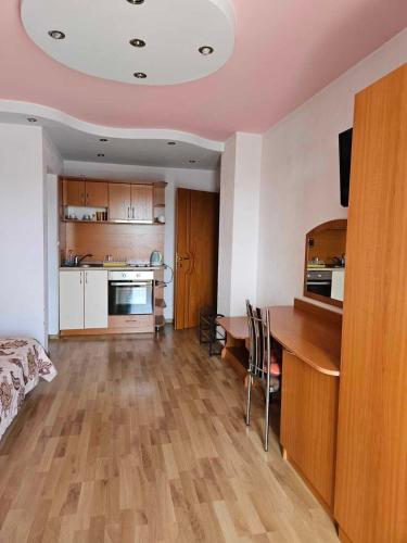 a living room with a kitchen and a dining room table at Apartments Center in Sandanski