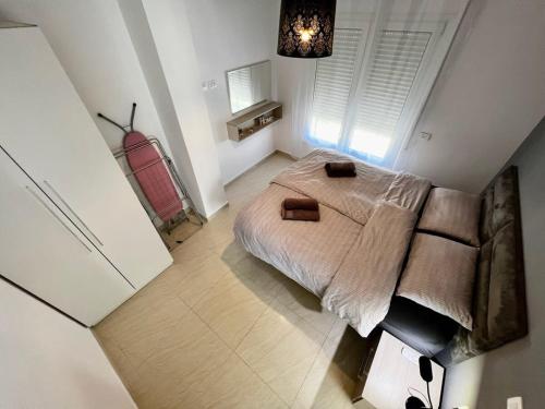 a small bedroom with a bed and a large window at Villa Golem 595 in Golem