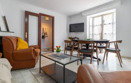 a living room with a table and chairs and a couch at Gorgeous Home In Chipiona With Wifi in Chipiona