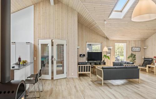 a living room with a couch and a table at Beautiful Home In Idestrup With Kitchen in Marielyst