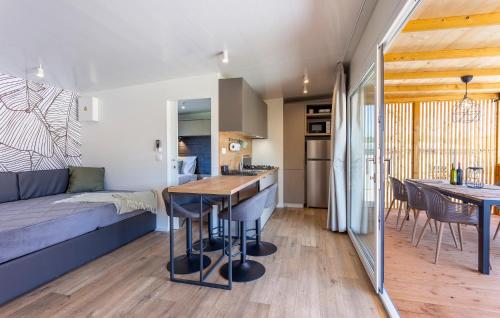 a kitchen and living room with a couch and a table at 2 Bedroom Amazing Home In Banjole in Banjole