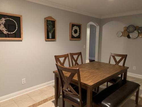 a dining room with a wooden table and chairs at Entire home! Waterfront and Trail-backing! in Beaufort