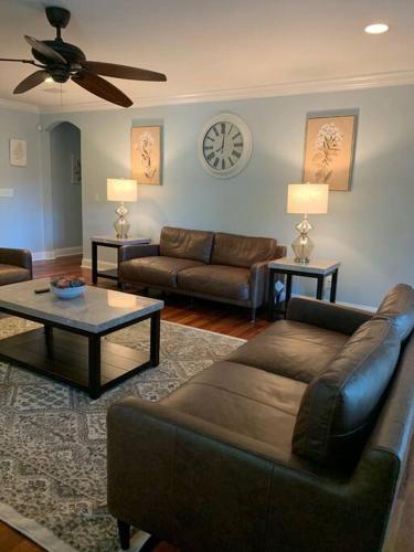 a living room with a couch and a table at Entire home! Waterfront and Trail-backing! in Beaufort