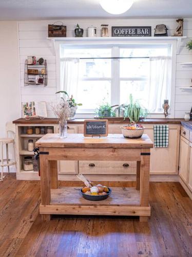 a kitchen with a coffee table with a bowl of fruit at Family friendly getaway in North Richland Hills