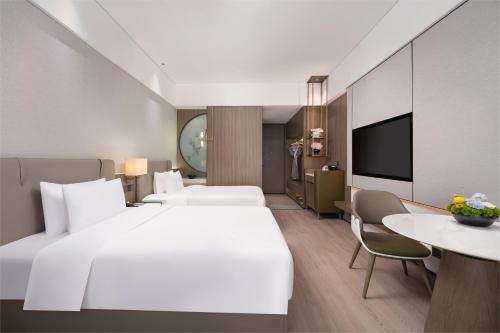 Ένα ή περισσότερα κρεβάτια σε δωμάτιο στο Edorer Hotel Shenzhen