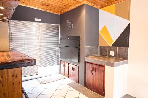 a kitchen with a counter and a refrigerator at Alakhe Self-Catering Accomodation Twin Bedroom in Oudtshoorn