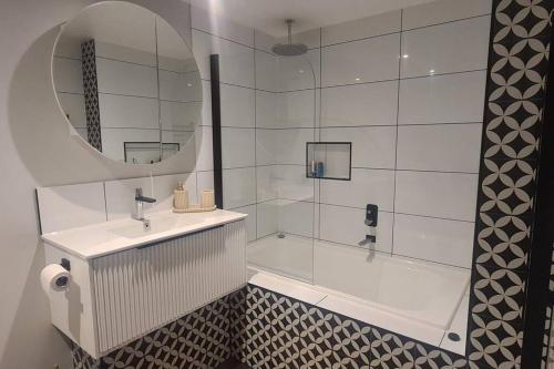a bathroom with a tub and a sink and a mirror at Bon Voyage in Werribee