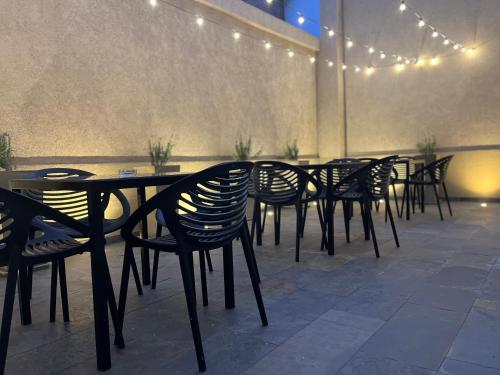 a row of tables and chairs in a room with lights at La Sofia Apart & Wines in Mendoza