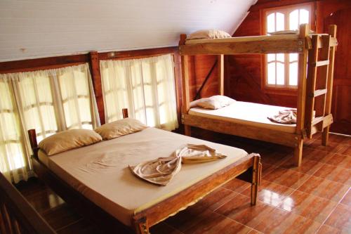 two bunk beds in a room with windows at Hipilandia International Hostel in Leticia