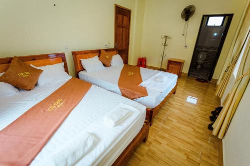 Postel nebo postele na pokoji v ubytování Hotel CÔ CÚC