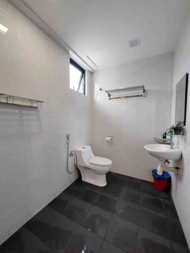 a bathroom with a toilet and a sink at Landmark2 Spacious Studio w Wi-Fi Netflix in Kajang
