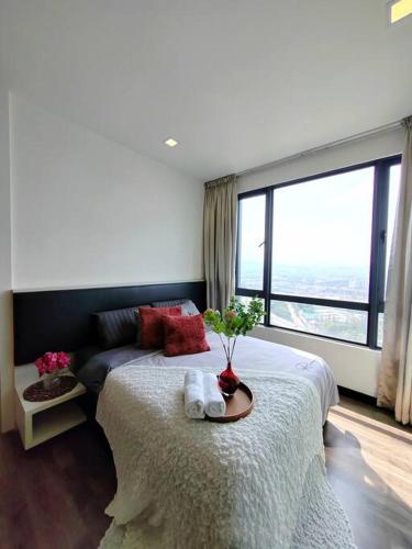 a bedroom with a bed and a large window at Landmark2 Spacious Studio w Wi-Fi Netflix in Kajang