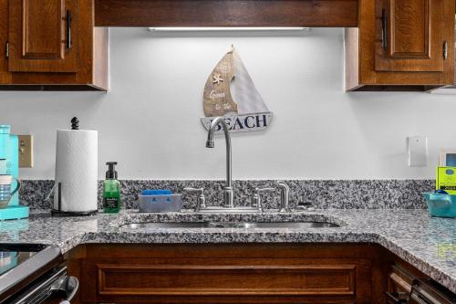 a kitchen sink with a boat sign on the wall at Salty Air Retreat in Myrtle Beach