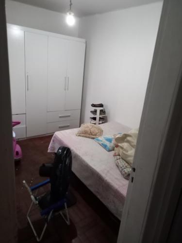a bedroom with a bed and a chair in it at Condomínio Verdes Mares in Aracaju