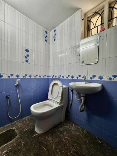 a bathroom with a toilet and a sink at Chilanka Place HOME AWAY FROM HOME - Ernakulam- Kerala in Cochin