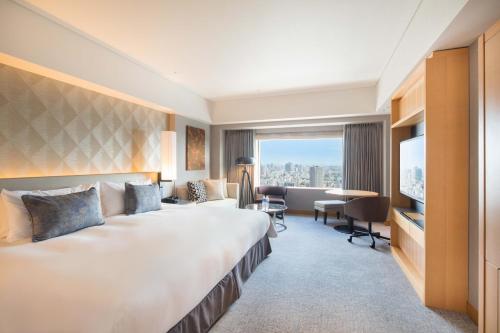 a hotel room with a large bed and a desk at Cerulean Tower Tokyu Hotel, A Pan Pacific Partner Hotel in Tokyo
