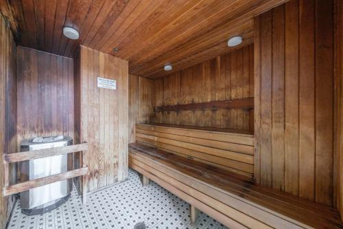 a wooden sauna with a toilet in it at Sub-Penthouse Apartment with Jacuzzi Pool & Sauna in Vancouver