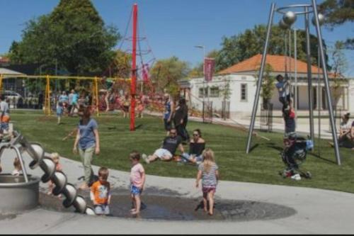 a group of children playing in a park at Soak in Cedar Tub, Stroll to Havelock Village in Havelock North