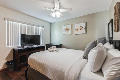 a bedroom with a bed and a flat screen tv at 10-Guest Home- National City Scenic Sunsets in National City