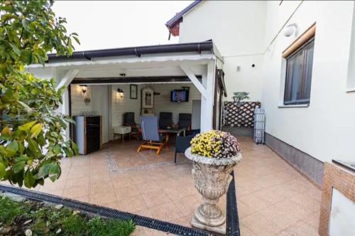 a patio with a vase with flowers in it at BLUE in Timişoara