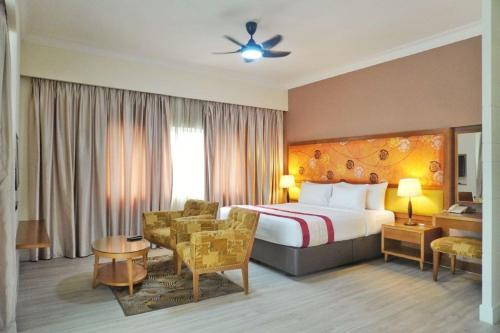 a hotel room with a bed and a chair at The Avenue M in Johor Bahru