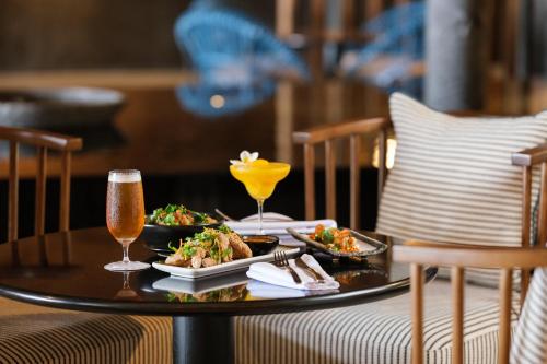 a table with two plates of food and drinks on it at Crowne Plaza Fiji Nadi Bay Resort & Spa by IHG in Nadi