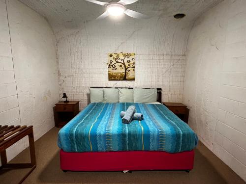 a bedroom with a bed with a stuffed animal on it at Desert View Apartments in Coober Pedy