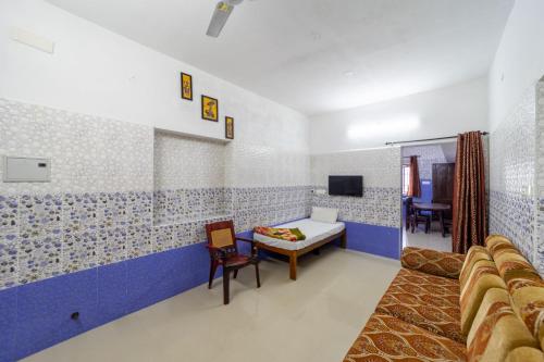 a hospital room with a bed and a tv at Sri Nandha Luxury Comforts in Vālpārai