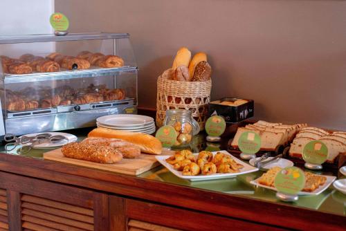 a buffet with bread and pastries on a table at Palissandre ANTANANARIVO in Antananarivo