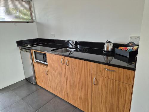 a kitchen with a sink and a counter top at Auto Lodge in New Plymouth