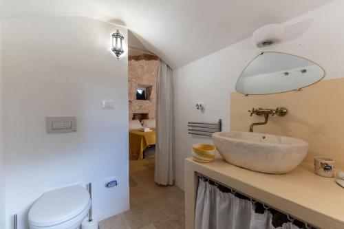 a bathroom with a sink and a toilet at Charming Villa in San Vito dei Normanni in San Vito dei Normanni