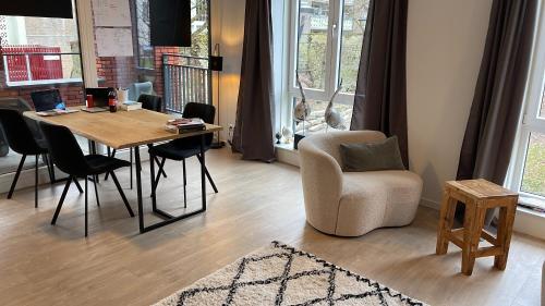 a living room with a table and a chair at Calvarie-studio in Maastricht