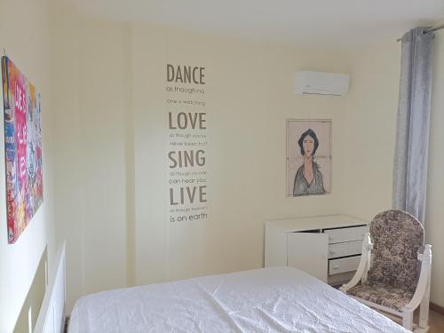 a white bedroom with a bed and a desk at Il Giardino degli Ulivi in Giugliano in Campania