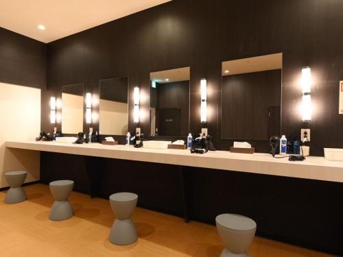a bathroom with three sinks and two mirrors at The Centurion Sauna Rest & Stay Sapporo Male Only in Sapporo