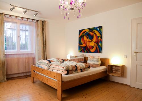 a bedroom with a bed and a painting on the wall at Ferienwohnung Weintraube in Dresden