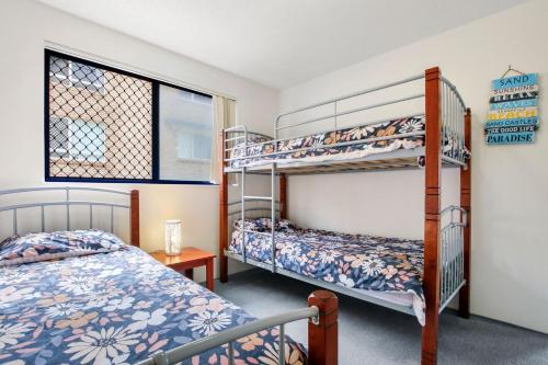 a bedroom with two bunk beds and a window at Jade Waters U4 5 Latona Ave in Caloundra