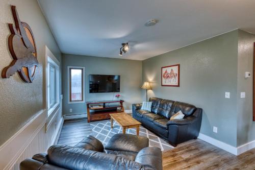 a living room with a couch and a table at Captivating Coastline 2 BR Retreat with Ocean View in Kodiak