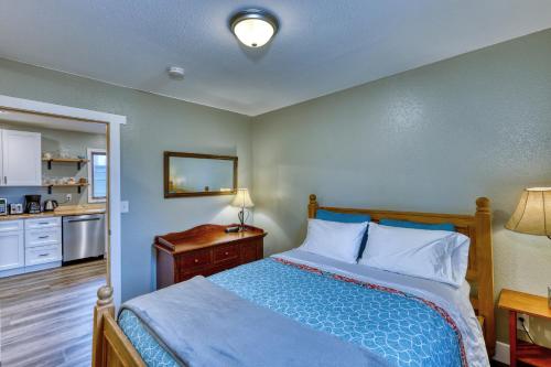 a bedroom with a bed and a table and a kitchen at Captivating Coastline 2 BR Retreat with Ocean View in Kodiak